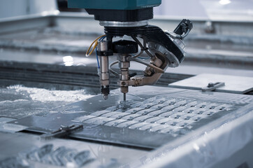 Modern CNC Abrasive water jet cutting machine using high pressure water jet to cut metal....