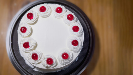 White cream cake with red jelly ball toping - homemade bakery concept