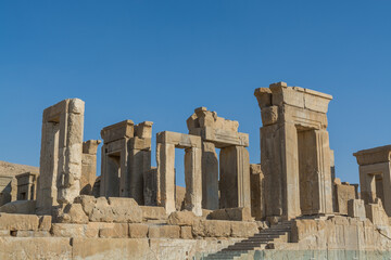 Fototapeta premium Ruins of the stone Gates in Persepolis, the ceremonial capital of the Achaemenid Empire, UNESCO declared the ruins of Persepolis a World Heritage Site in 1979.