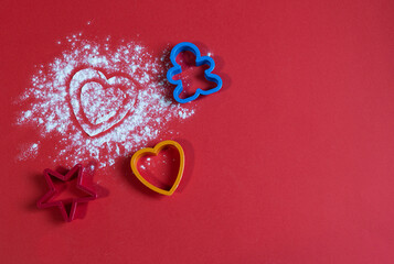 Bakery products. Flour is scattered on the table in the form of hearts. Form for gingerbread....