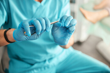 Professional doctor podiatry working with different equipment in medical clinic