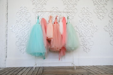 Hanger with colorful elegant puffy dresses for girls. holiday wardrobe. 