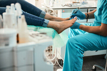 Professional doctor podiatrist doing medical pedicure procedure in the cabinet - obrazy, fototapety, plakaty