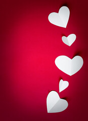 white paper hearts on red background, paper art copy space for text