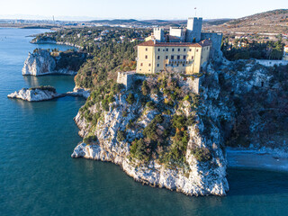 Aerial view of gothic Duino castle on a cliff over the Gulf of Trieste , Italy. 
