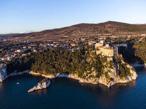 Aerial view of gothic Duino castle on a cliff over the Gulf of Trieste , Italy. 