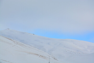 snow on the mountain with clouds