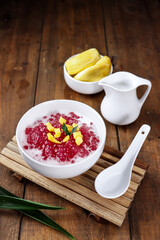 Indonesian dessert or sweet snack Bubur Sagu Mutiara. Made from pearl sago (sagu mutiara), sugar,Pandan leaves, and coconut milk, topping with jackfruit. Very famous during Ramadhan