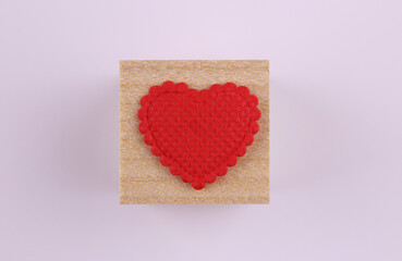 Heart on a wooden cube on a white background