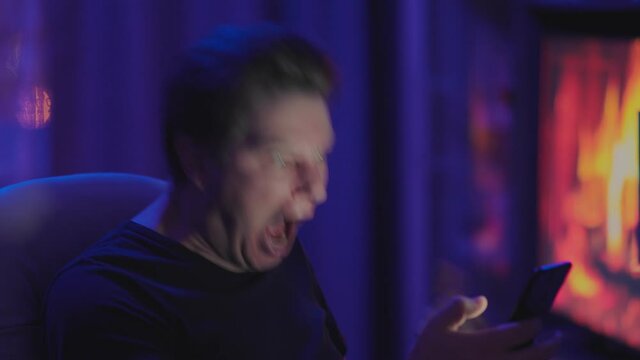 Angry man screams and swears with the phone