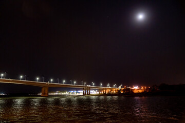 Fototapeta na wymiar night. road bridge over the river with lights. 