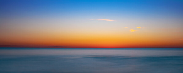 Naklejka na ściany i meble Blue and orange sky after sunset over the Gulf of Mexico from Venice Florida USA