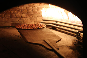 In a restaurant, pita or pide bread cooking in oven or stove. Bakery or bakehouse concept image.