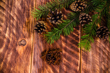 Christmas cones and branches on wooden boards. - 401244453