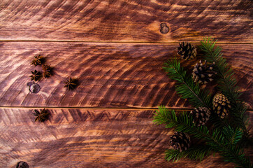 Christmas cones and branches on wooden boards. - 401244628