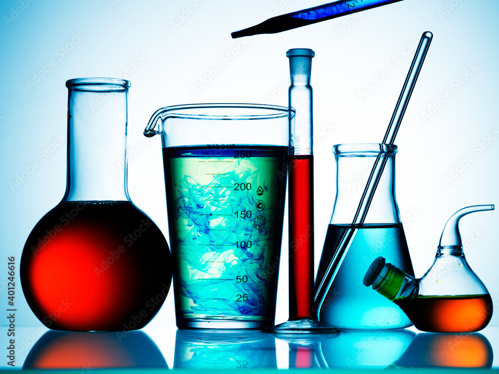 Wall mural different laboratory glassware with color liquid and with reflection