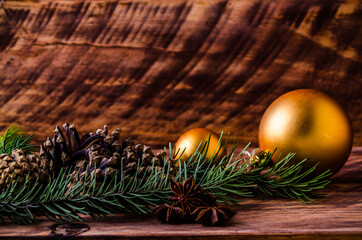cones and branches on wooden boards with a large Christmas ball. - 401247661