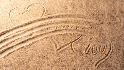 Fototapeta na wymiar Beach sand with romantic phrases written in the sand, selective focus.