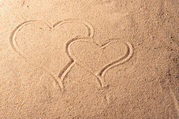 Beach sand with romantic phrases written in the sand, selective focus.