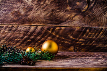 cones and branches on wooden boards with a large Christmas ball. - 401248075