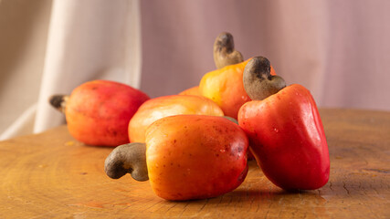 Cashews with fabrics in the background on rustic wood, low depth of field, selective focus.