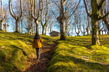 Young girl on the trekking trail in the Oianleku beech forest, in the town of Oiartzun, Gipuzkoa....