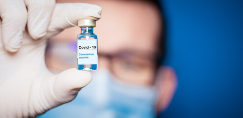 doctor holding covid - 19 coronavirus vaccine