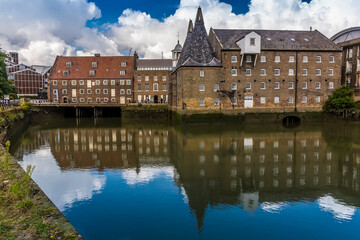 Eighteen-century mills reflected in the still waters of the River Lee in Lee Valley, London in the summertime