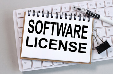 software license, text on white paper on white keyboard on gray background