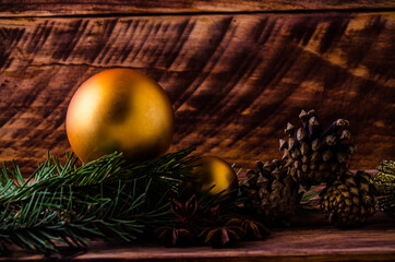 cones and branches on wooden boards with a large Christmas ball. - 401249684