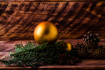 cones and branches on wooden boards with a large Christmas ball. - 401249896