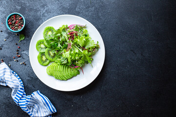kiwi salad avocado lettuce mix leaves ready to cook and eat on the table for healthy meal snack outdoor top view copy space for text food background rustic image keto or paleo diet