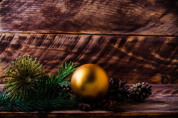 cones and branches on wooden boards with a large Christmas ball. - 401250813