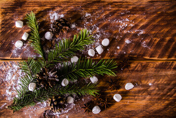 Christmas cones and branches on wooden marshmallow boards