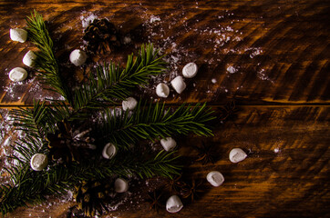 Christmas cones and branches on wooden marshmallow boards