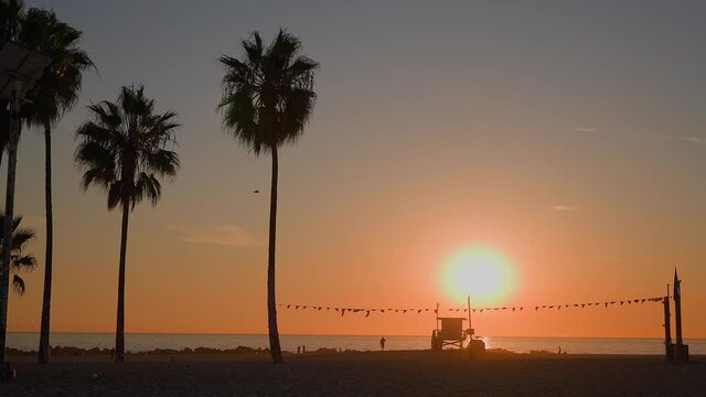 Lifeguard house on Venice Beach, California during golden hour. Slow motion.