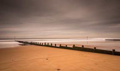 Fototapeta premium A stormy, cloudy and blustery day at Blyth beach in Northumberland, as the waves batter the coast