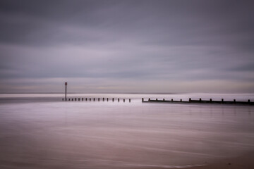 Fototapeta premium A stormy, cloudy and blustery day at Blyth beach in Northumberland, as the waves batter the coast