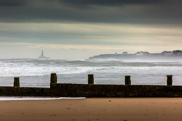 A stormy, cloudy and blustery day at Blyth beach in Northumberland, as the waves batter the coast