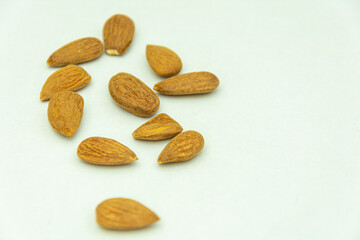 Raw dry almonds with white background and space for text