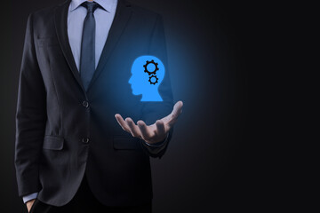 Businessman man holding a man icon with gears in his head. Artificial intelligence. Technology advances. Robot. Contour symbol.