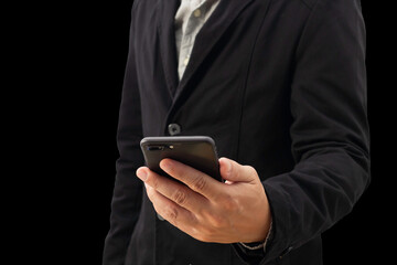 Close view of the left hand of a businessman in a black suit holding a smartphone on a white background with clipping path.