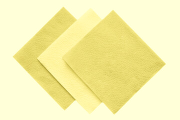 Paper napkins on white isolated, flat lay. Toned in Illuminating, trend of 2021.