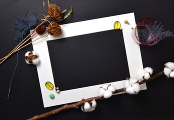 Background flatlay white frame on a black sheet with decor.