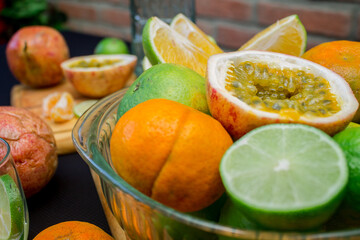 Parchita cut in half surrounded by a background of citrus fruits