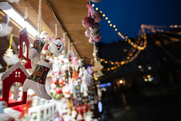 Christmas toys hanging in shop on Christmas market