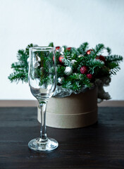 Glass glass on the background of a new year's bouquet. Serving, decoration of the festive table.