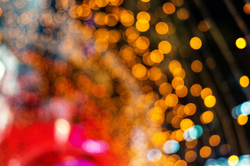 Christmas and New Year festive glitter bokeh background with red and gold colors.