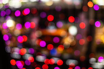 Christmas and New Year festive glitter bokeh background with red, purple and blue colors.