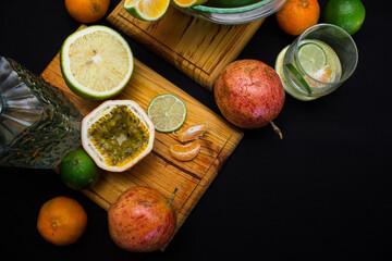 Conceptual composition of tropical citrus fruits with black background for copy space